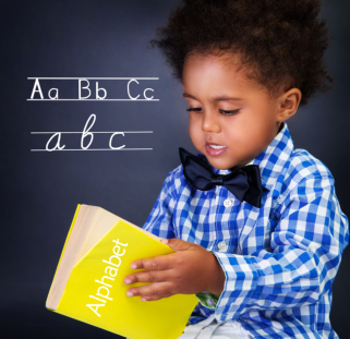 Little boy holding alphabet book