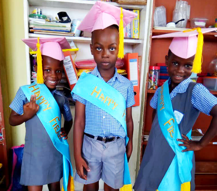 three kids wearing graduation cap