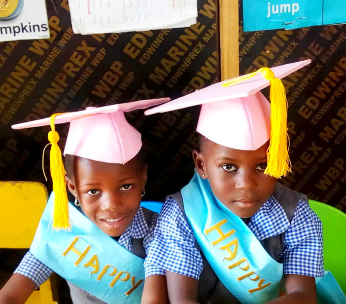 two kids wearing graduation cap